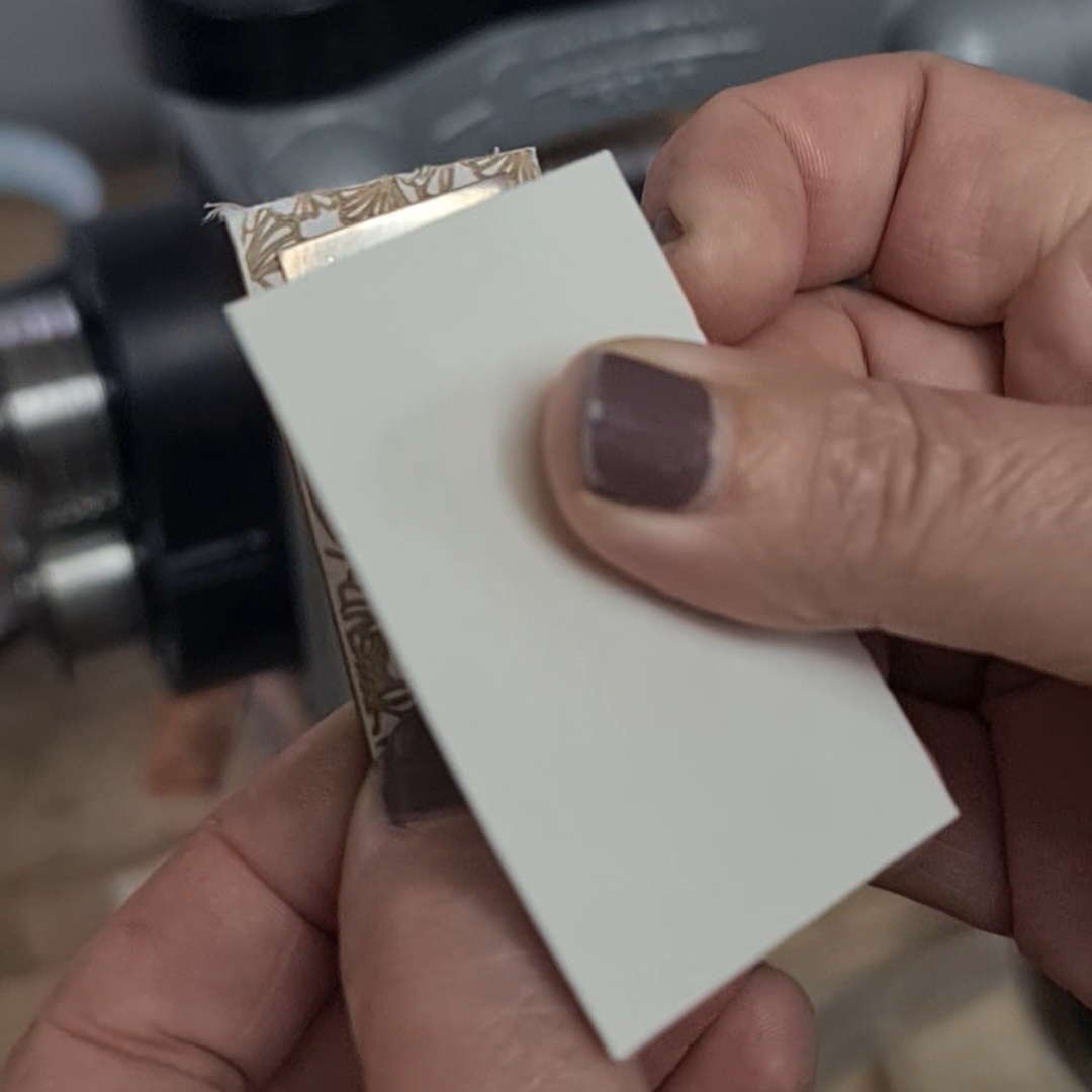 sandwich the metal between a piece of texturing sheet and a piece of watercolour paper